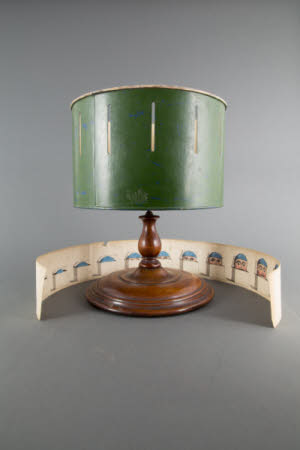 Zoetrope, drum on polished circular wood base with Jack in a Box strip inside.