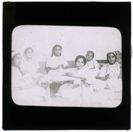 Six African girls doing needlecrafts.
