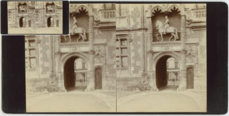 A mounted statue above an ornate gateway.