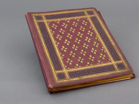 Red clothbound photographic album containing 28 mounted print photographs.