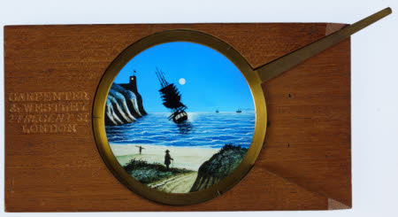 Single lever coloured hand-painted glass lantern slide of a ship in a bay.
