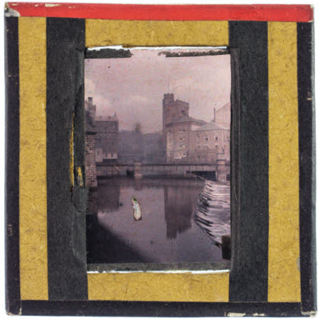 A river scene showing a bridge and a number of buildings