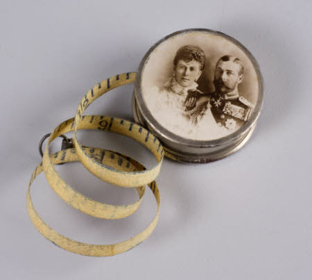 Tape measure in case depicting George V, Queen Mary and Prince Edward of Wales.