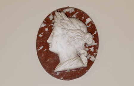 One of a Pair of White Roundel Marble Reliefs of Classical Heads on a red Marble background: Ceres: ...