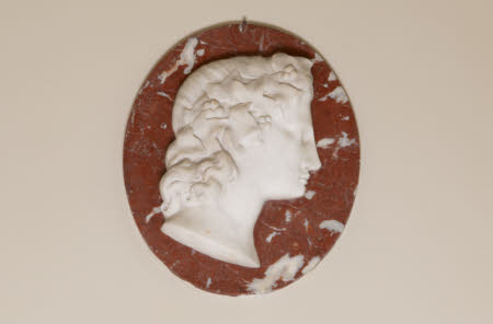 One of a Pair of White Roundel Marble Reliefs of Classical Heads on a red Marble background: ...