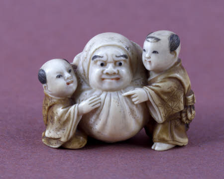 Netsuke of Daruma rolled by attendants